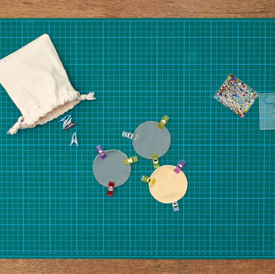 several facial rounds clipped on top of cutting mat. 