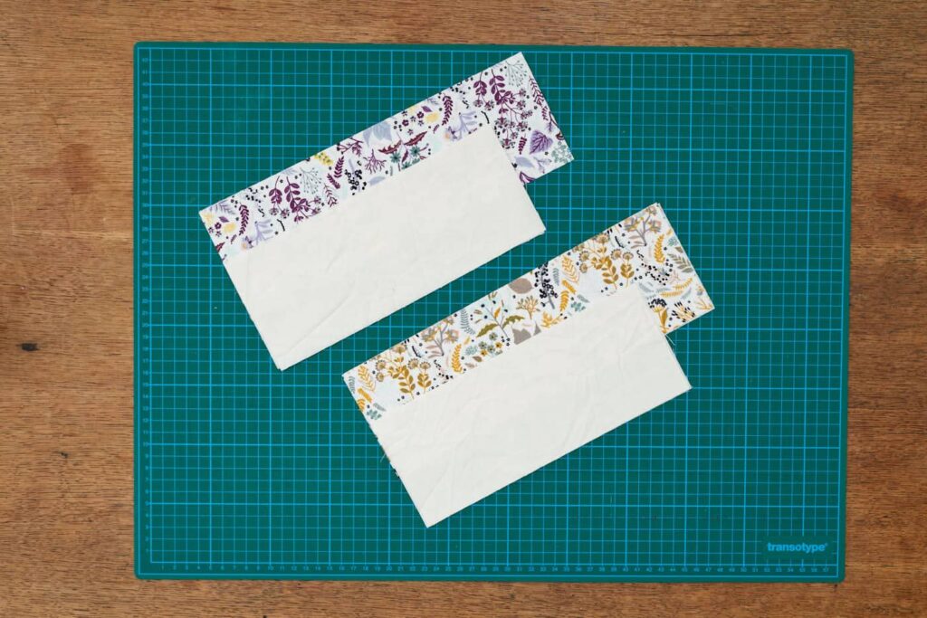 4 rectangular pieces of fabric on a green cutting mat