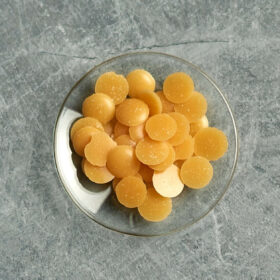 candelilla wax pellets on a small glas dish