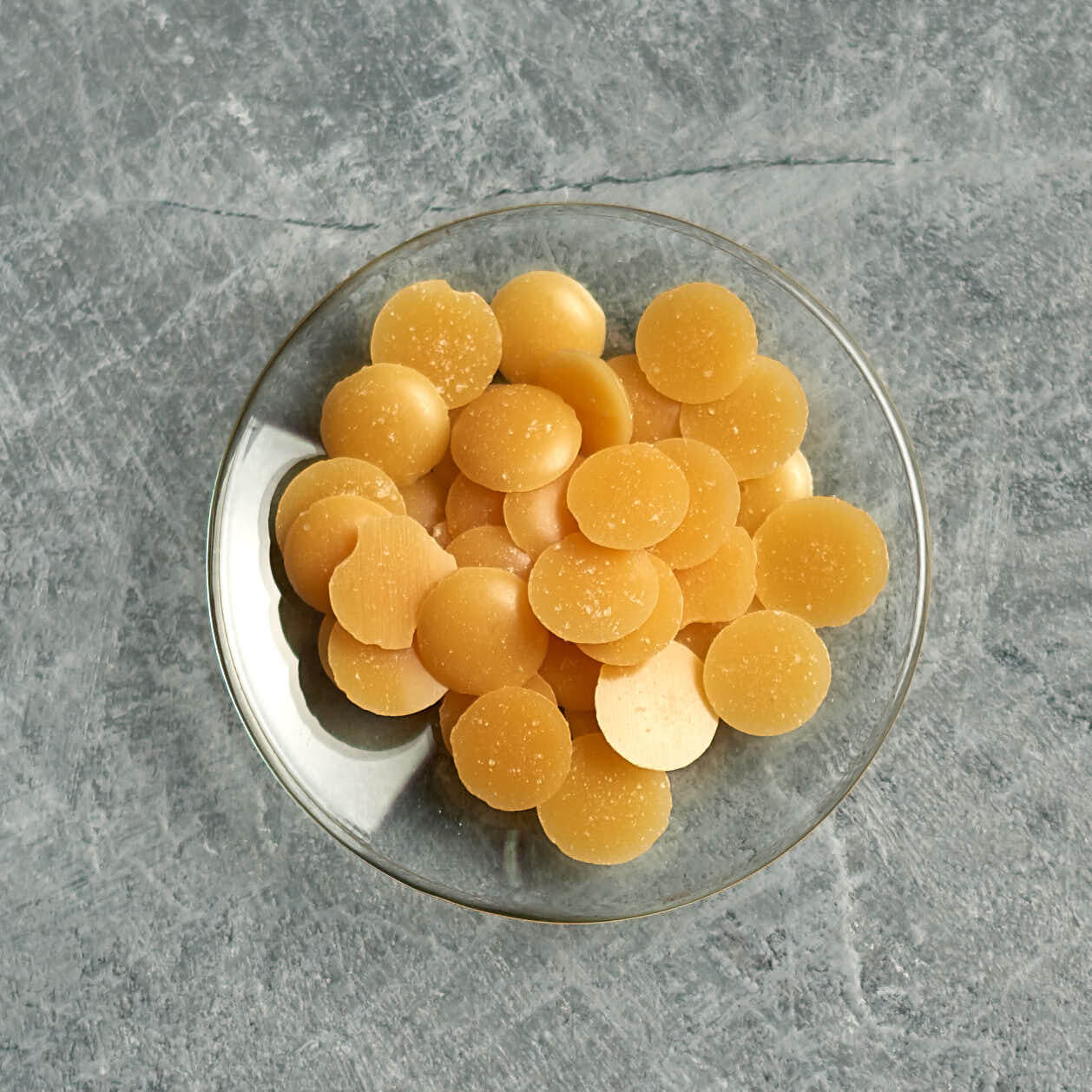candelilla wax pellets on a small glas dish