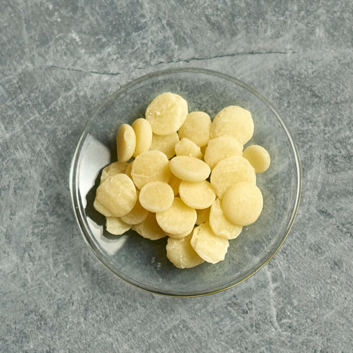 cocoa butter pellets on a small glass dish