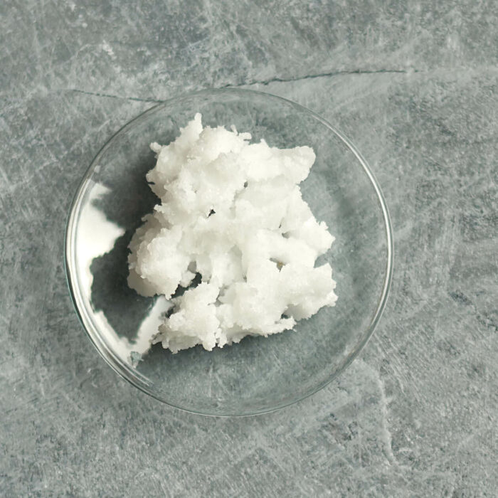 solid coconut oil on a small glass dish