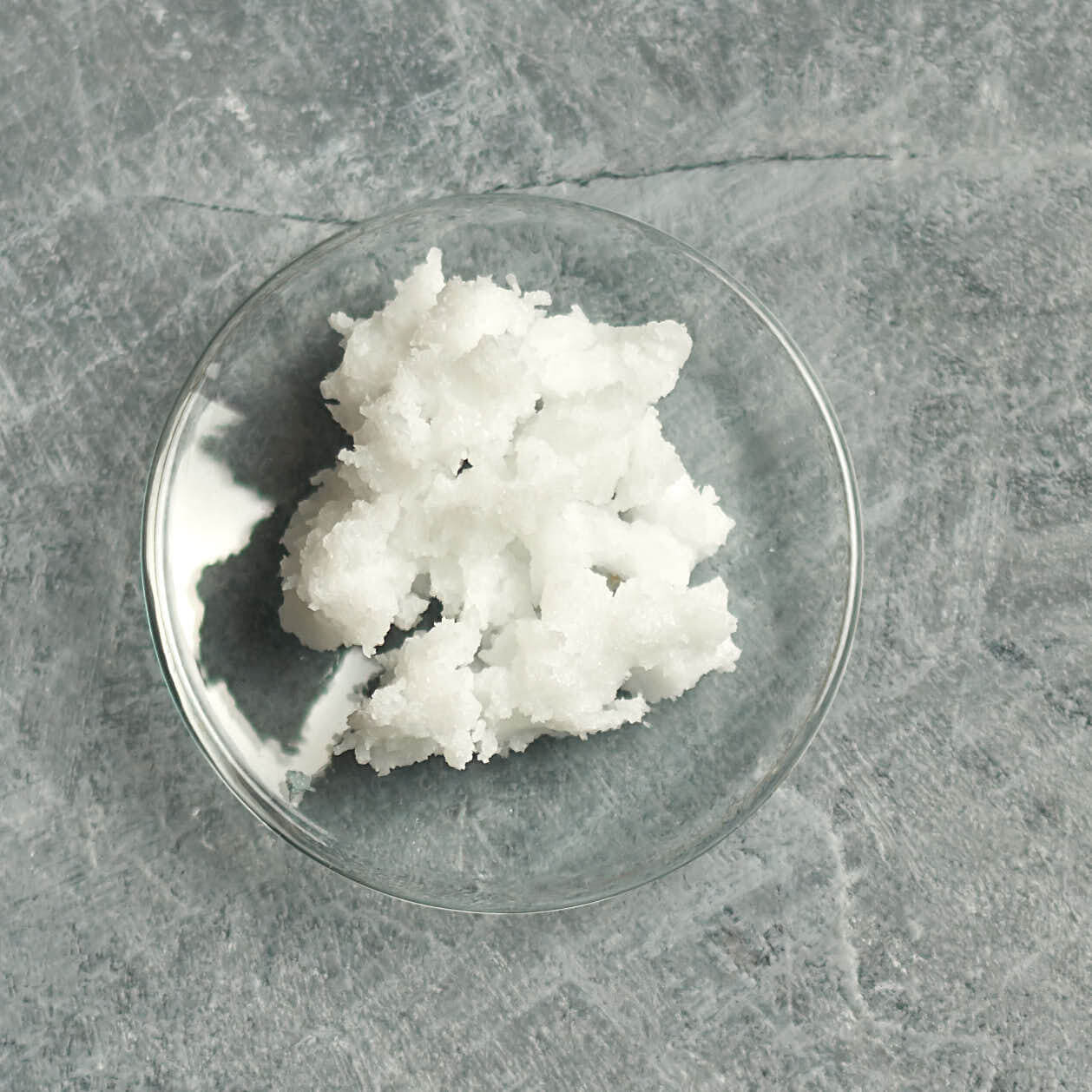 solid coconut oil on a small glass dish