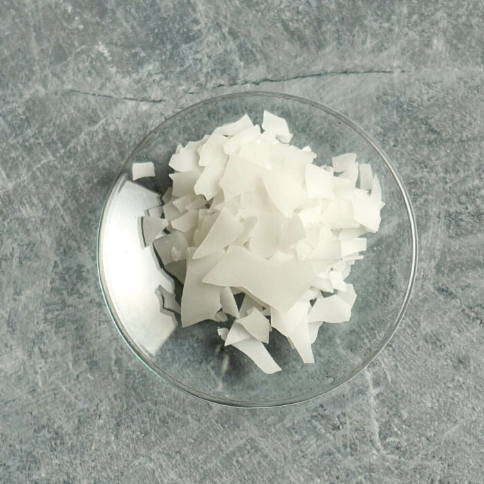 Olivem1000 flakes on a small glas dish